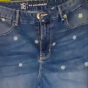 Capri jeans, covered in daisies.